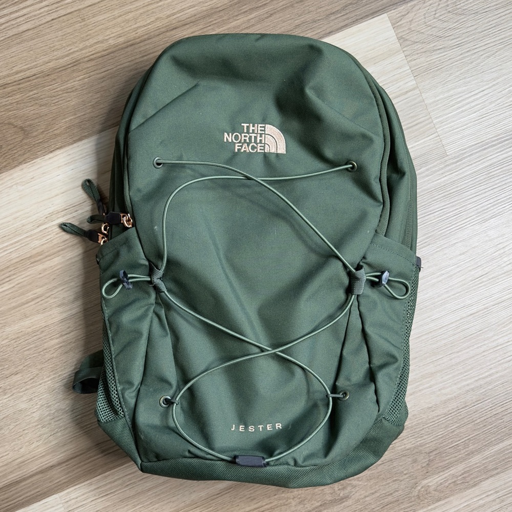 The North Face green Jester backpack with gold embroidery